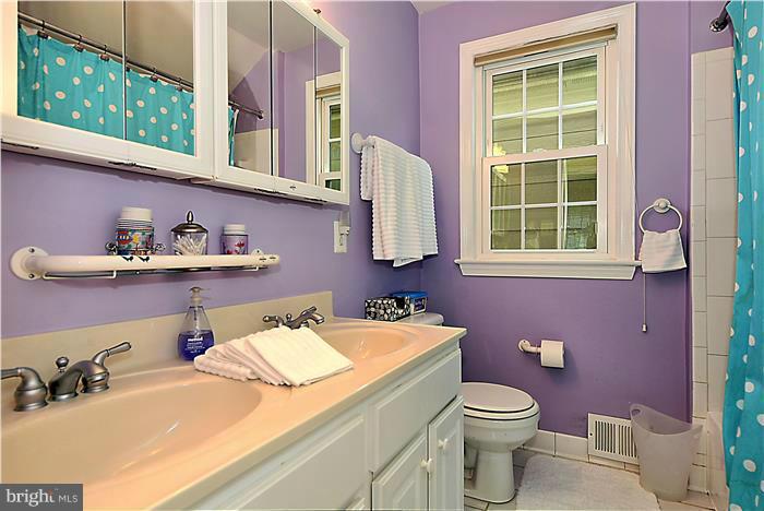 8731 Ridge Road Bethesda, MD 20817 - Photo 14 of 29 a bathroom with a sink a toilet and mirror