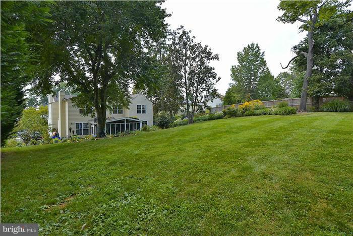 8731 Ridge Road Bethesda, MD 20817 - Photo 28 of 29 a view of a house with a big yard potted plants and large trees