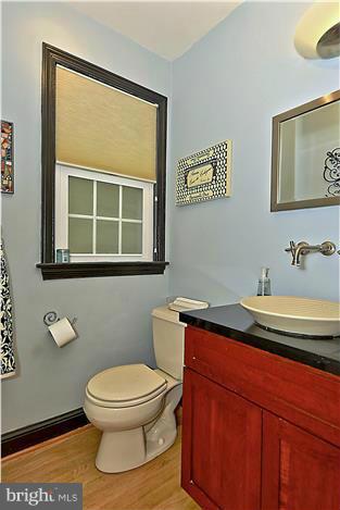 8731 Ridge Road Bethesda, MD 20817 - Photo 7 of 29 a bathroom with a toilet a sink and mirror
