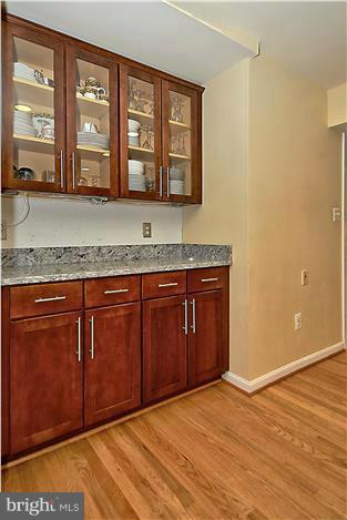 8731 Ridge Road Bethesda, MD 20817 - Photo 9 of 29 a view of a kitchen with stainless steel appliances granite countertop a sink and wooden cabinets