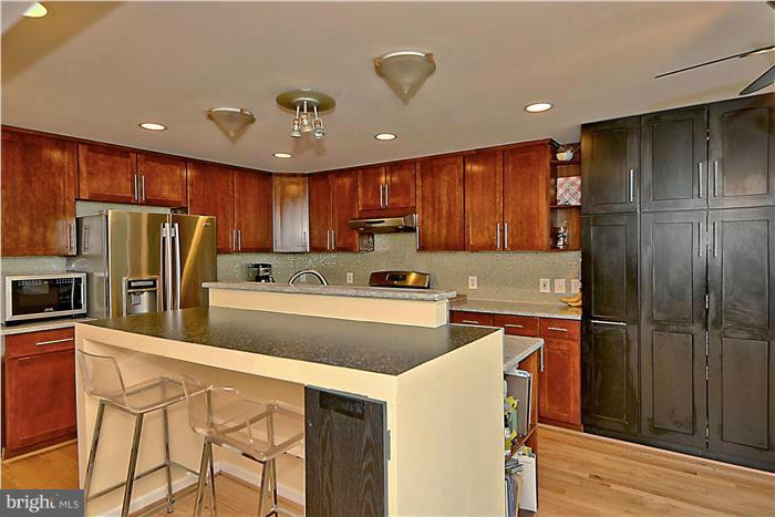 8731 Ridge Road Bethesda, MD 20817 - Photo 10 of 29 a kitchen with stainless steel appliances a refrigerator stove microwave and cabinets