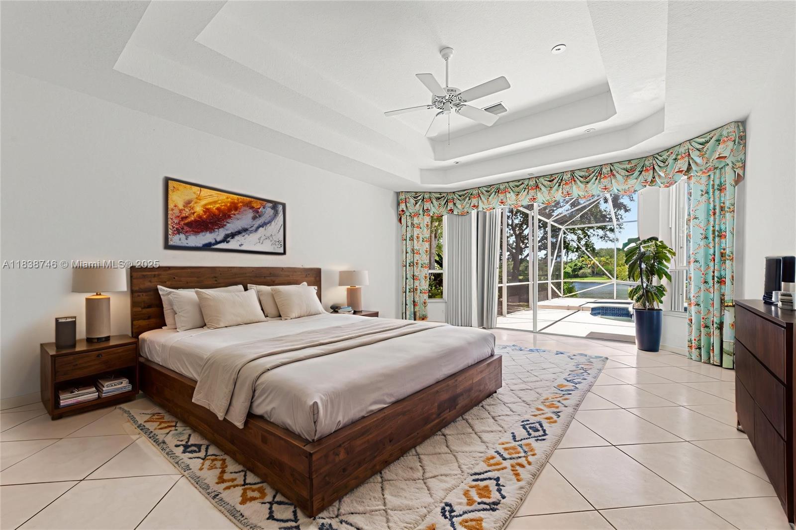 3833 Pine Lake Drive Weston, FL 33332 - Photo 12 of 46 a spacious bedroom with a large bed and a chandelier