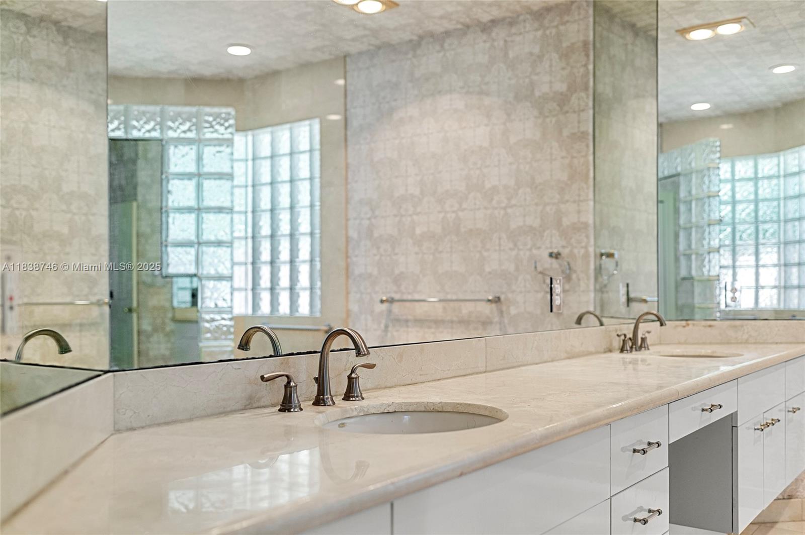 3833 Pine Lake Drive Weston, FL 33332 - Photo 16 of 46 a bathroom with double vanity sinks and a bathtub