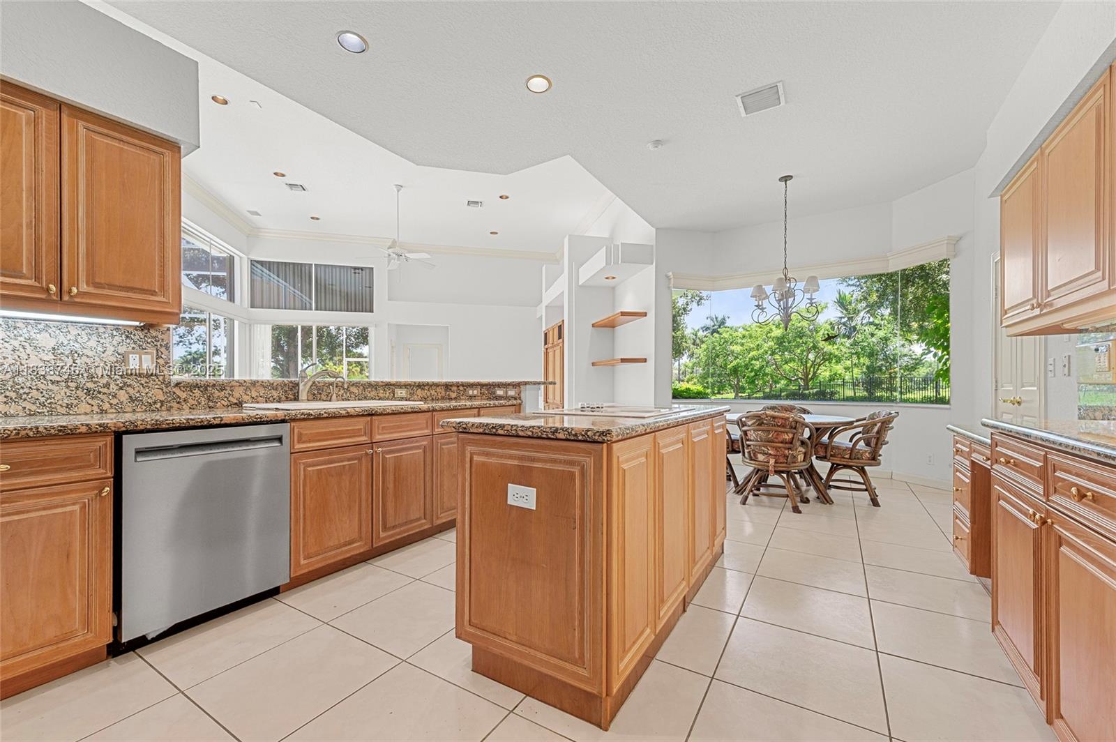 3833 Pine Lake Drive Weston, FL 33332 - Photo 24 of 46 a kitchen with stainless steel appliances granite countertop a sink and cabinets