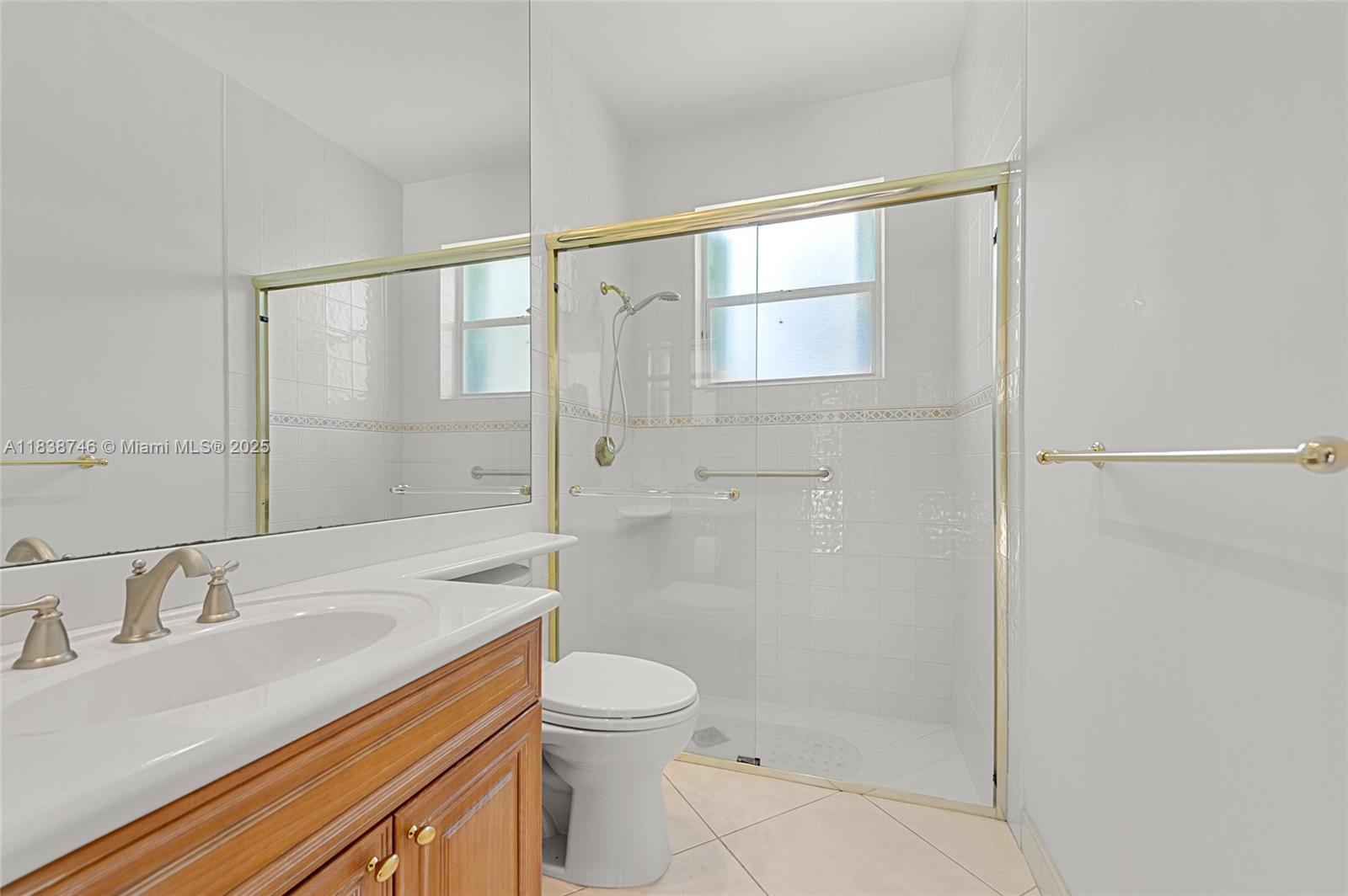 3833 Pine Lake Drive Weston, FL 33332 - Photo 29 of 46 a bathroom with a sink a toilet and shower