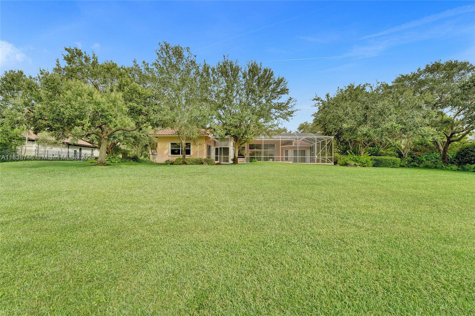 3833 Pine Lake Drive Weston, FL 33332 - Photo 41 of 46 a view of a green field with trees in the background