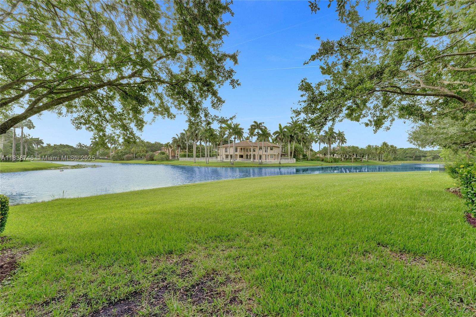 3833 Pine Lake Drive Weston, FL 33332 - Photo 42 of 46 a view of a green field with wooden fence