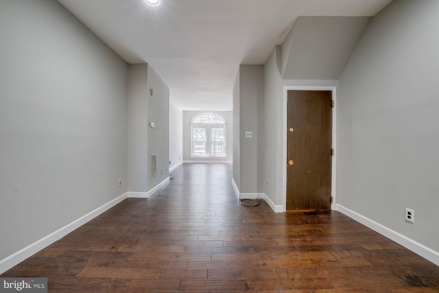 1522 East Baltimore Street, Unit 1 Baltimore, MD 21231 - Photo 12 of 26 a view of an empty room with wooden floor and a window