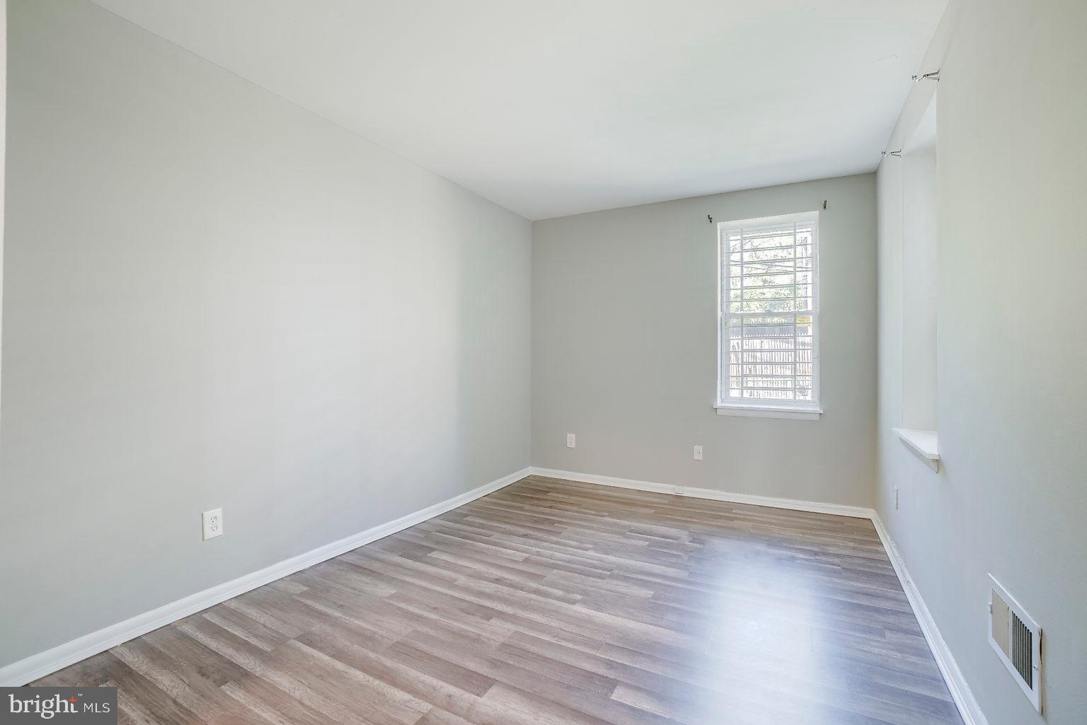 1522 East Baltimore Street, Unit 1 Baltimore, MD 21231 - Photo 19 of 26 wooden floor in an empty room with a window