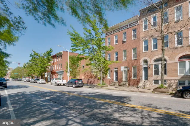 a view of a street with a building in the background