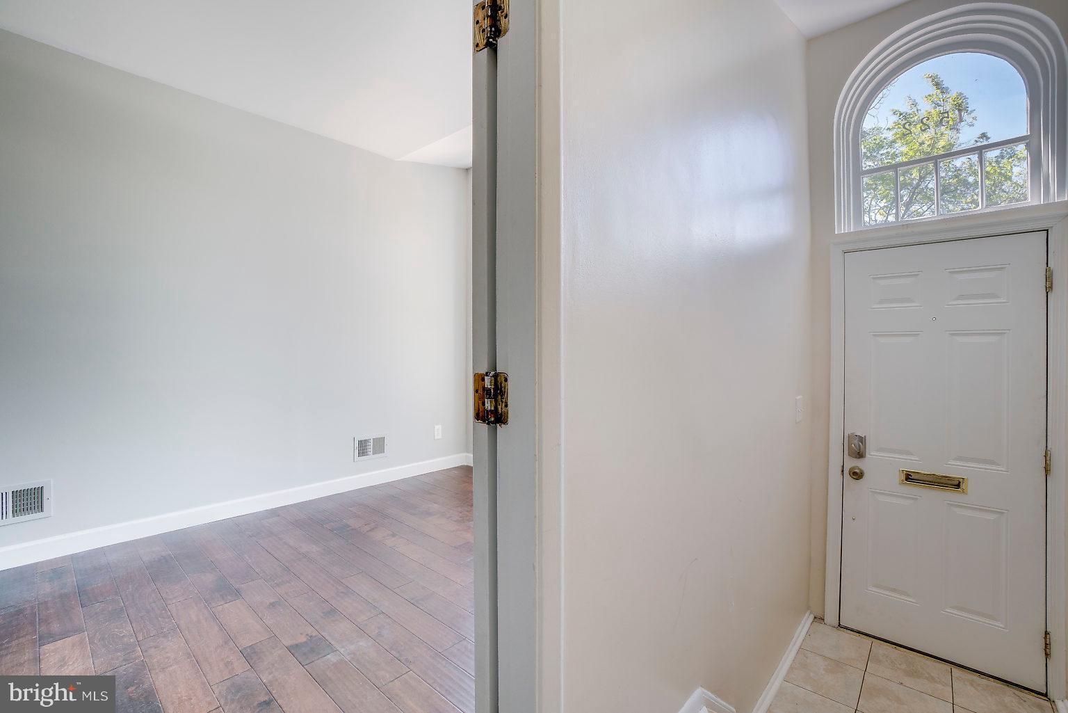 1522 East Baltimore Street, Unit 1 Baltimore, MD 21231 - Photo 7 of 26 an empty room with window wooden floor and garden view