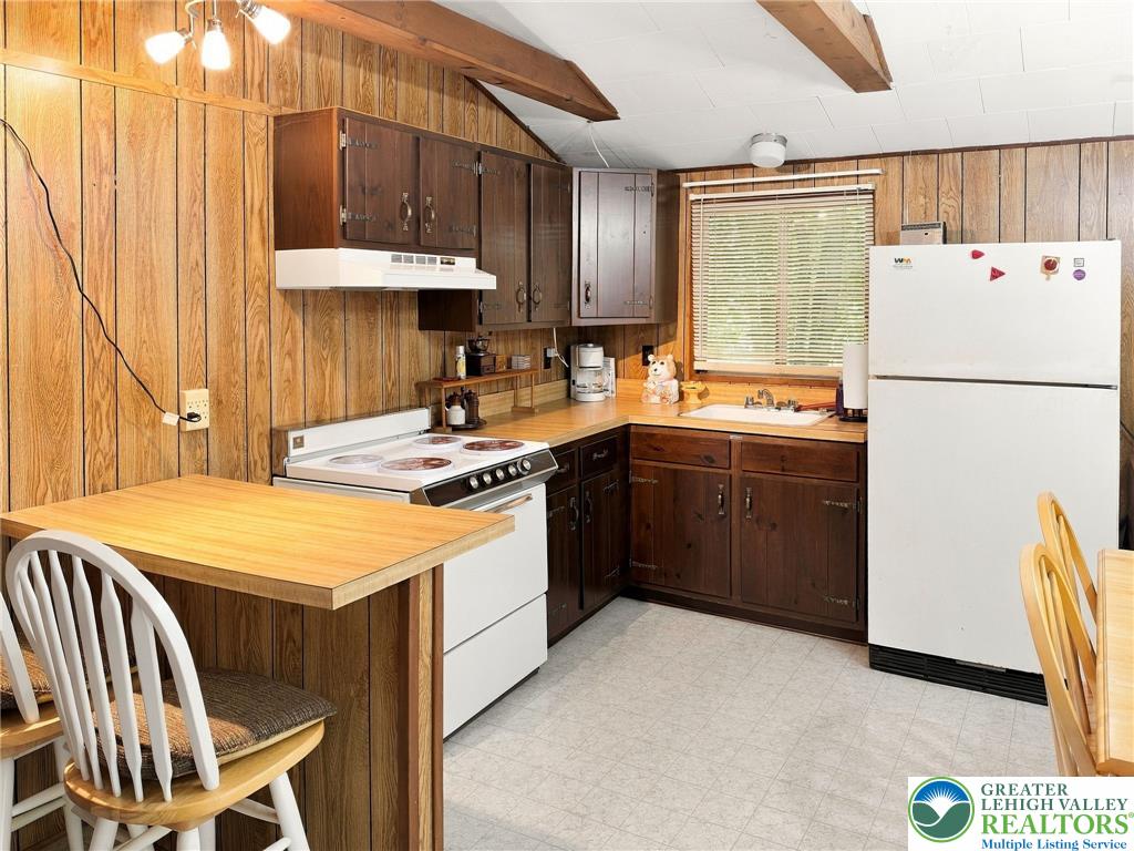 116 Aspen Road Albrightsville, PA 18210 - Photo 26 of 33 Warm wood paneling pairs with exposed ceiling beams in this cozy, functional cooking space.