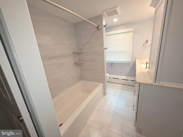 a bathroom with a sink a toilet and a bathtub