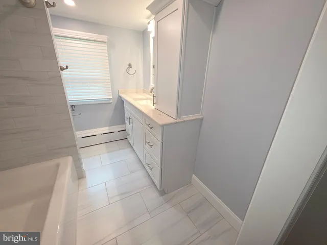 a bathroom with a toilet a sink and a mirror