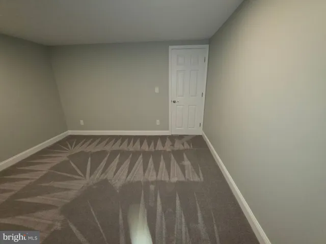 a view of a room with wooden floor and a window