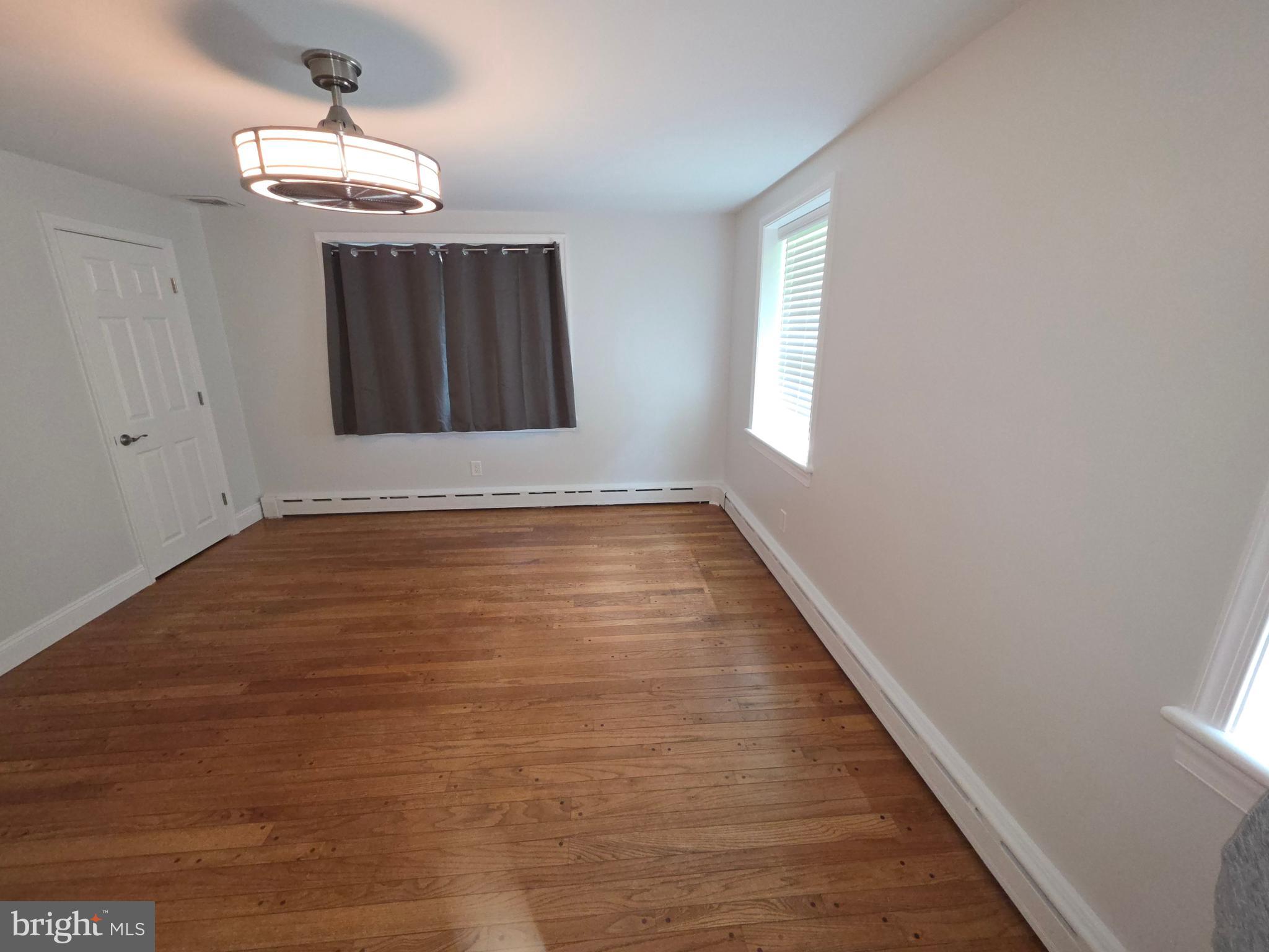 139 Mattson Road Garnet Valley, PA 19060 - Photo 33 of 61 a view of an empty room with chandelier and wooden floor