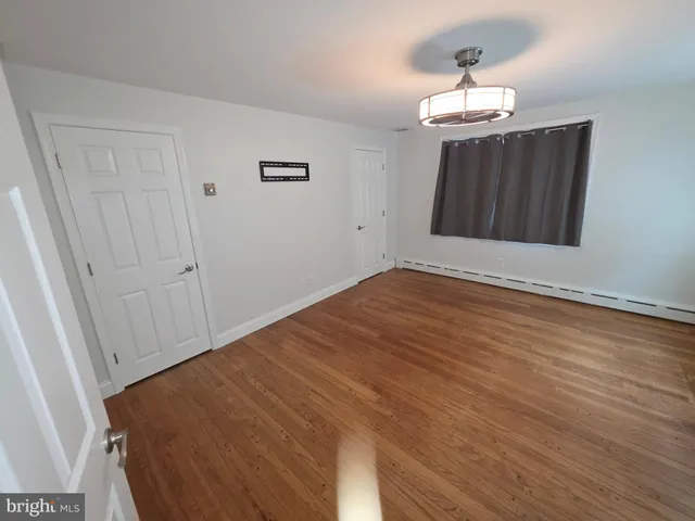 a view of a room with wooden floor and window