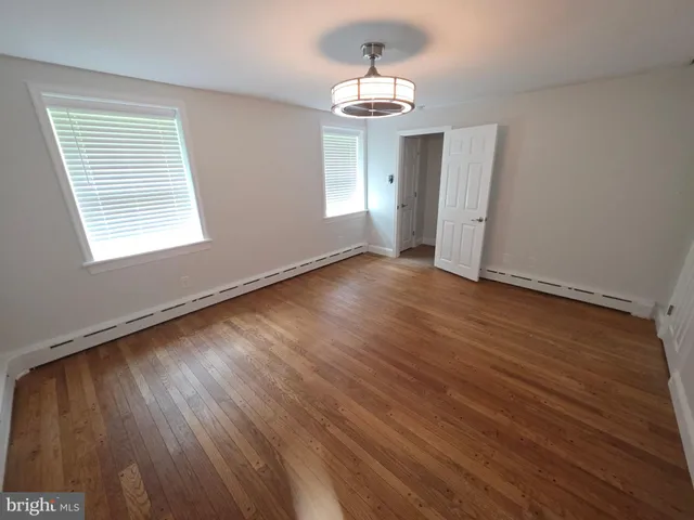 an empty room with wooden floor
