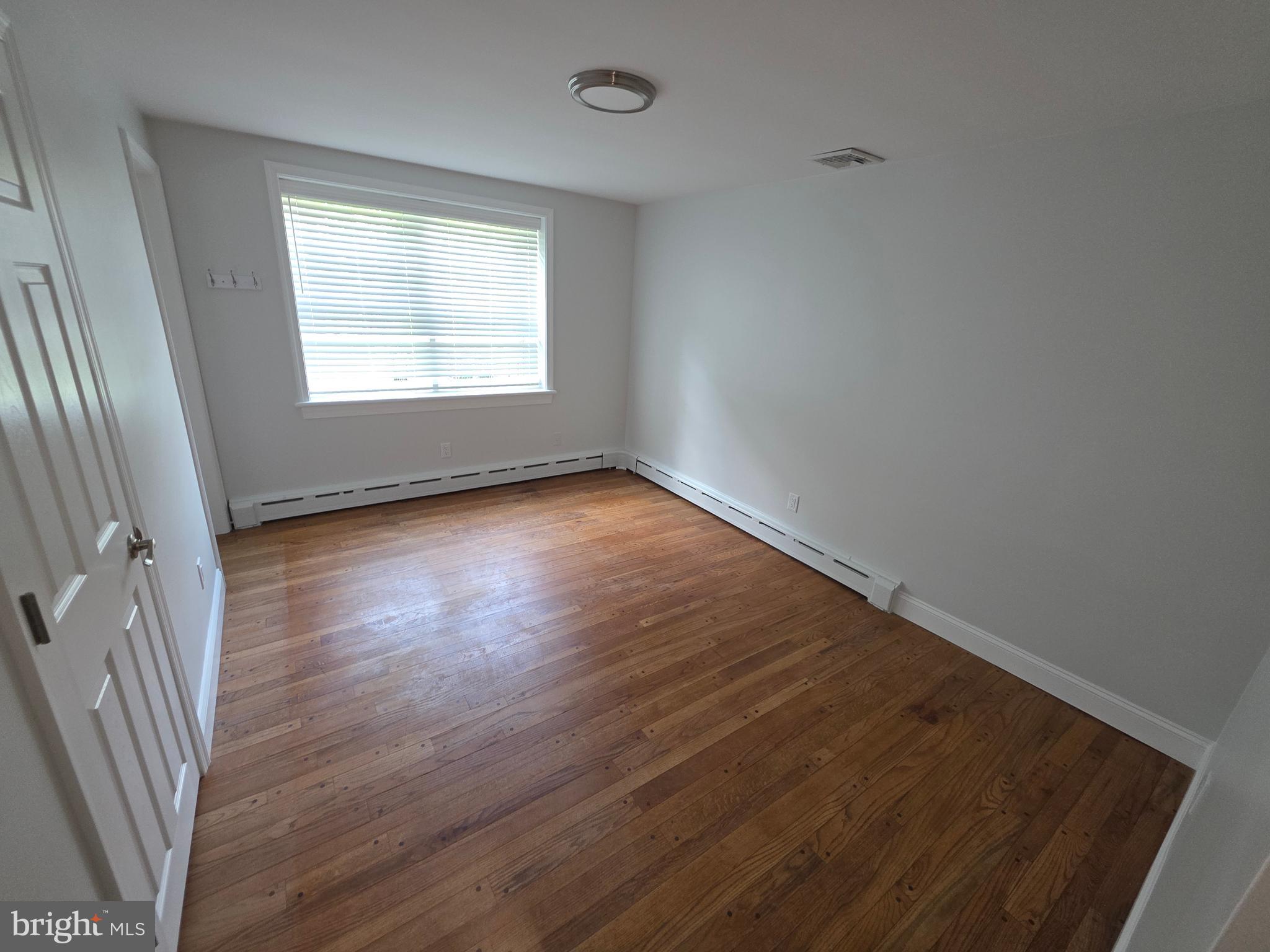 139 Mattson Road Garnet Valley, PA 19060 - Photo 38 of 61 an empty room with wooden floor and windows