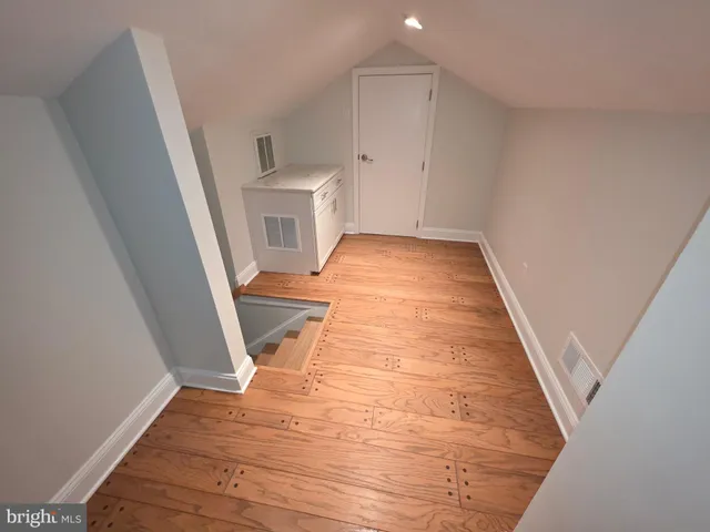 a view of a room with wooden floor