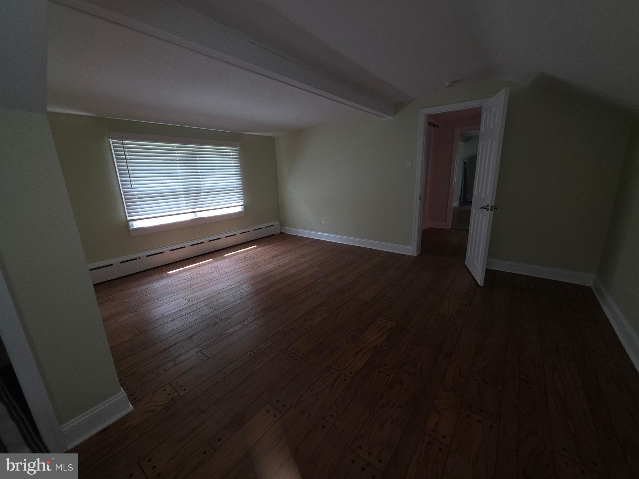 139 Mattson Road Garnet Valley, PA 19060 - Photo 54 of 61 a view of an empty room with wooden floor and a window