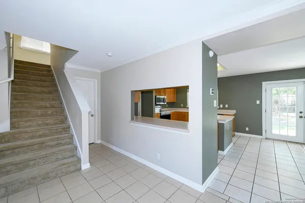 a view of an entryway with wooden floor and windows