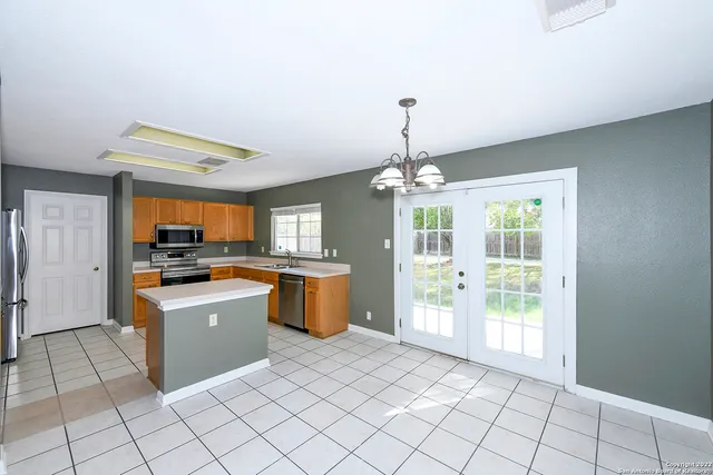 a view of a kitchen with natural light
