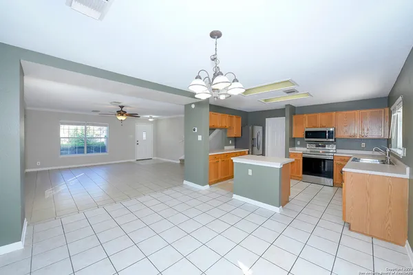 a large kitchen with kitchen island granite countertop lots of counter top space