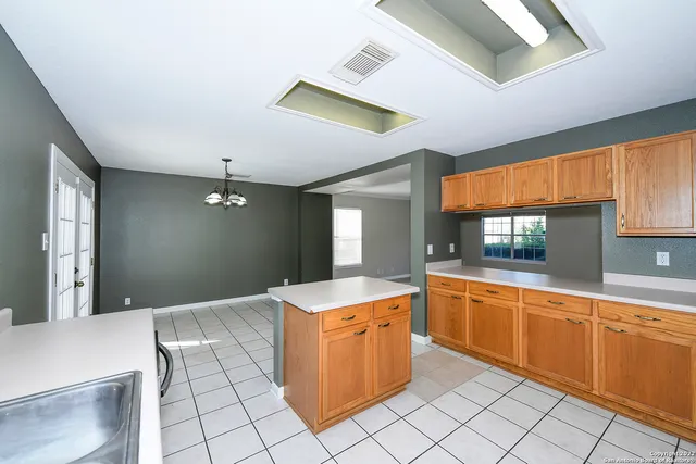 a kitchen with a sink and cabinets