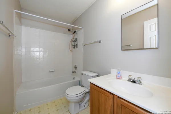 a bathroom with a sink toilet vanity and shower