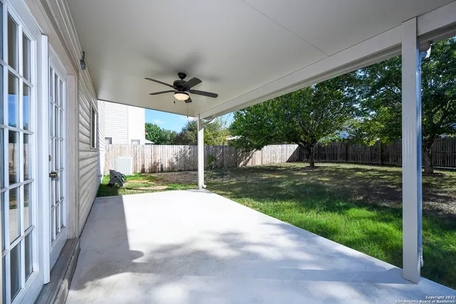 a view of a house with backyard and a garden
