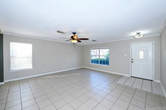 a view of an empty room with a window