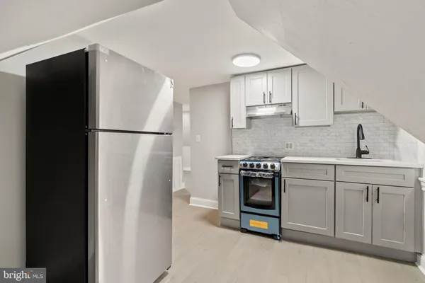a kitchen with a refrigerator and a sink