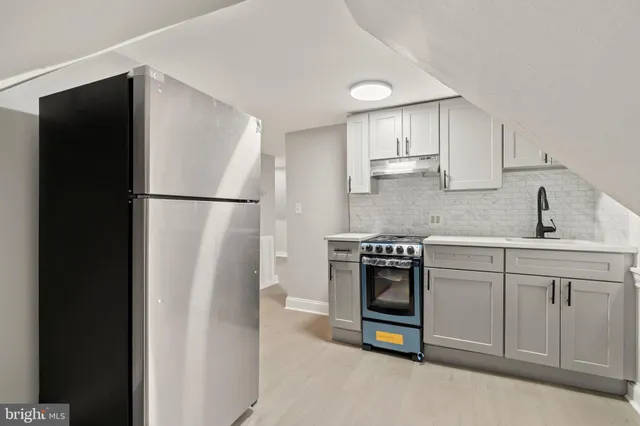 a kitchen with a refrigerator and a sink