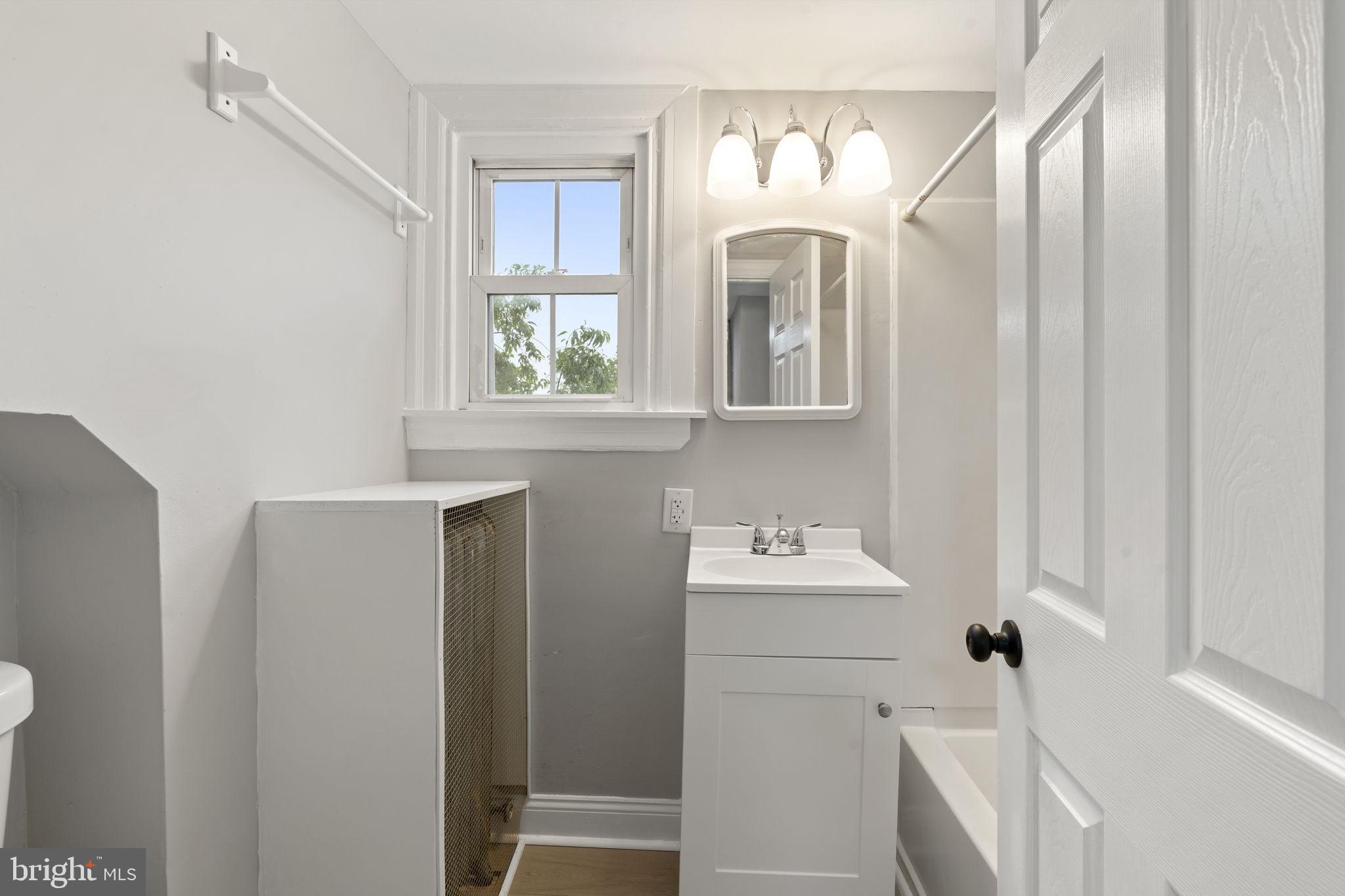 216 Collingdale Avenue, Unit 5 Collingdale, PA 19023 - Photo 8 of 12 a bathroom with a sink and a mirror