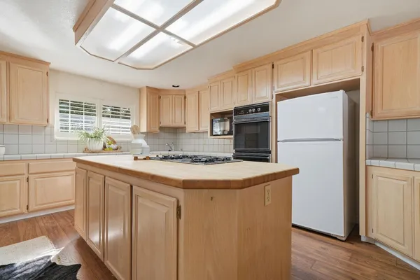 a kitchen with a stove a sink and a refrigerator