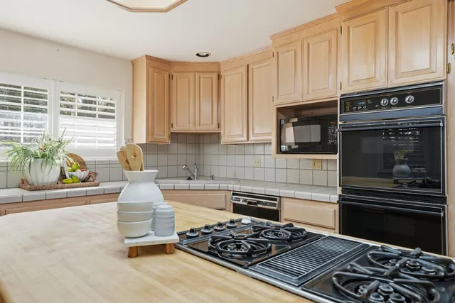 a living room with furniture and floor to ceiling window