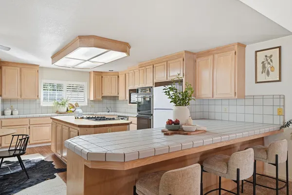 a kitchen with furniture a stove and a refrigerator