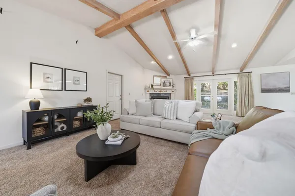 a living room with furniture and a fireplace