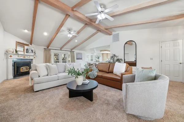 a kitchen with stainless steel appliances granite countertop a table chairs sink and cabinets