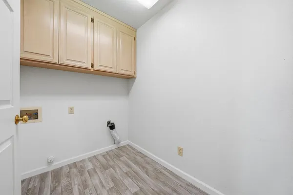 a view of a small house with a yard