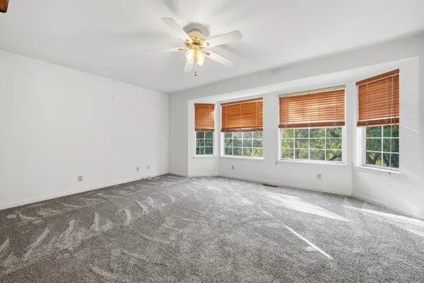 a view of a house with a yard and sitting area