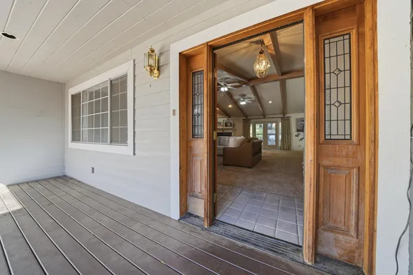 a spacious bedroom with a bed couch and window