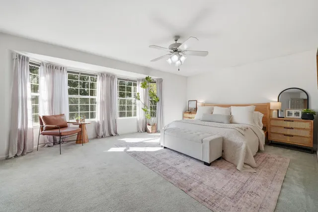 a living room with furniture a large window and a fireplace