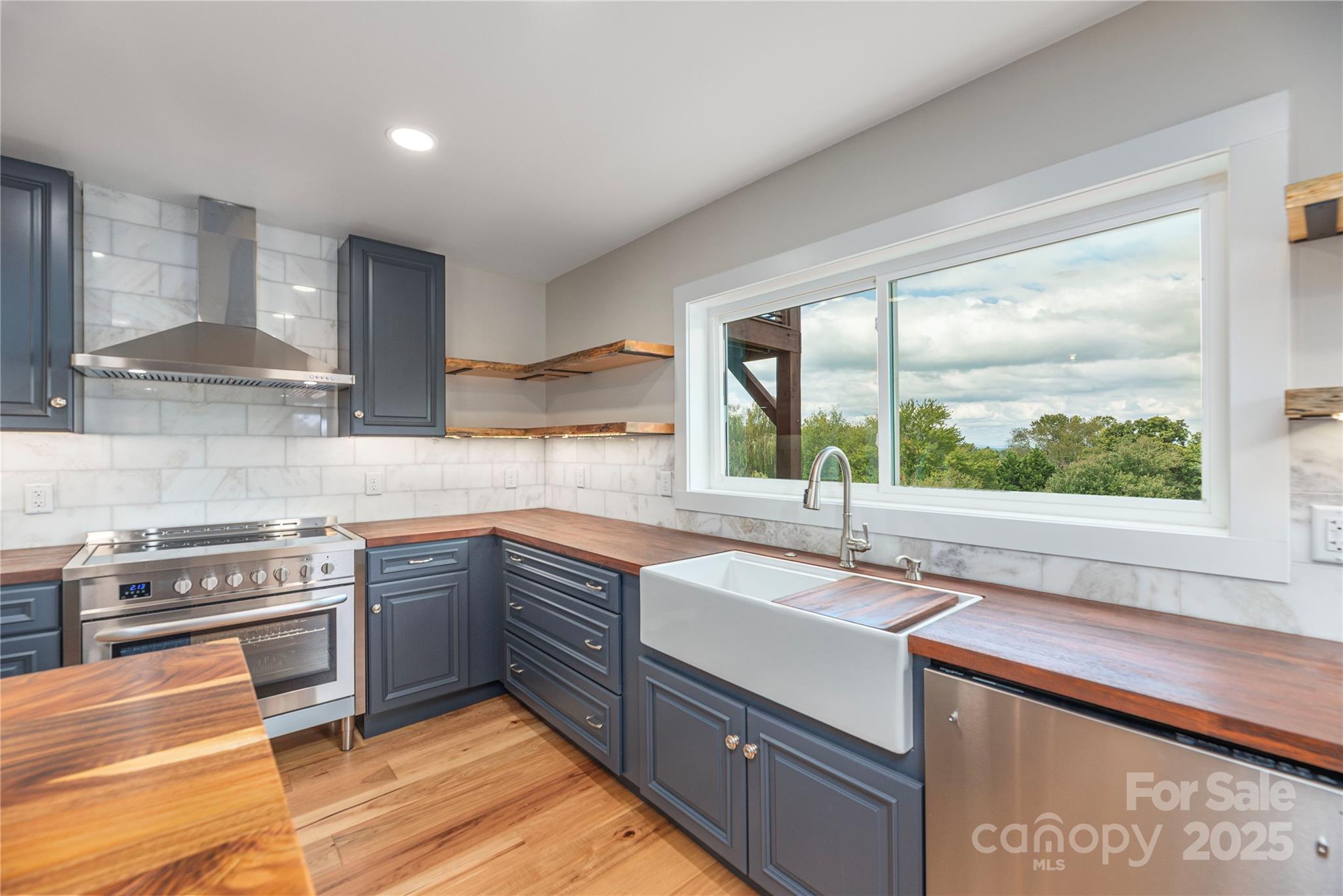 234 Erwin Hills Road Asheville, NC 28806 - Photo 11 of 47 a kitchen with stainless steel appliances granite countertop a sink stove and cabinets