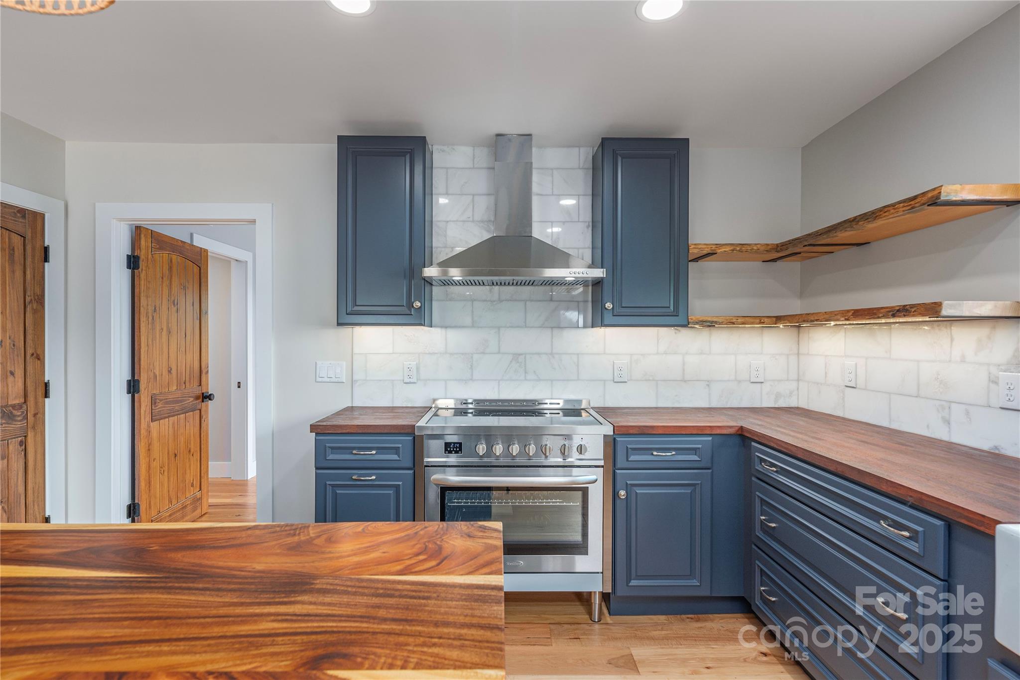 234 Erwin Hills Road Asheville, NC 28806 - Photo 12 of 47 a kitchen with stainless steel appliances granite countertop a stove and a sink