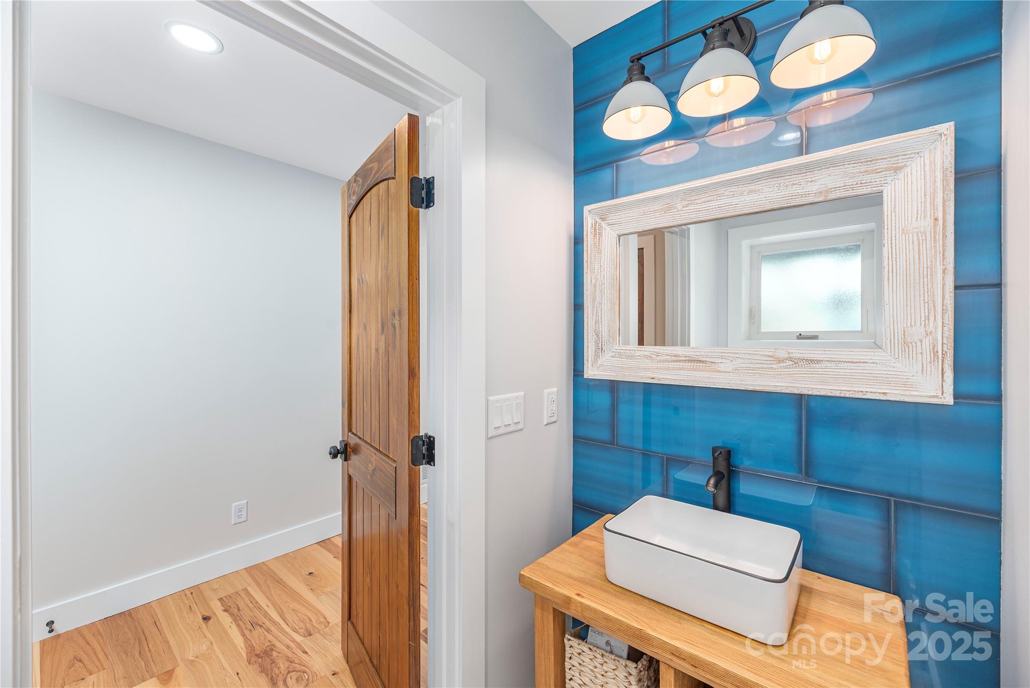 234 Erwin Hills Road Asheville, NC 28806 - Photo 14 of 47 a bathroom with a sink a vanity and a mirror