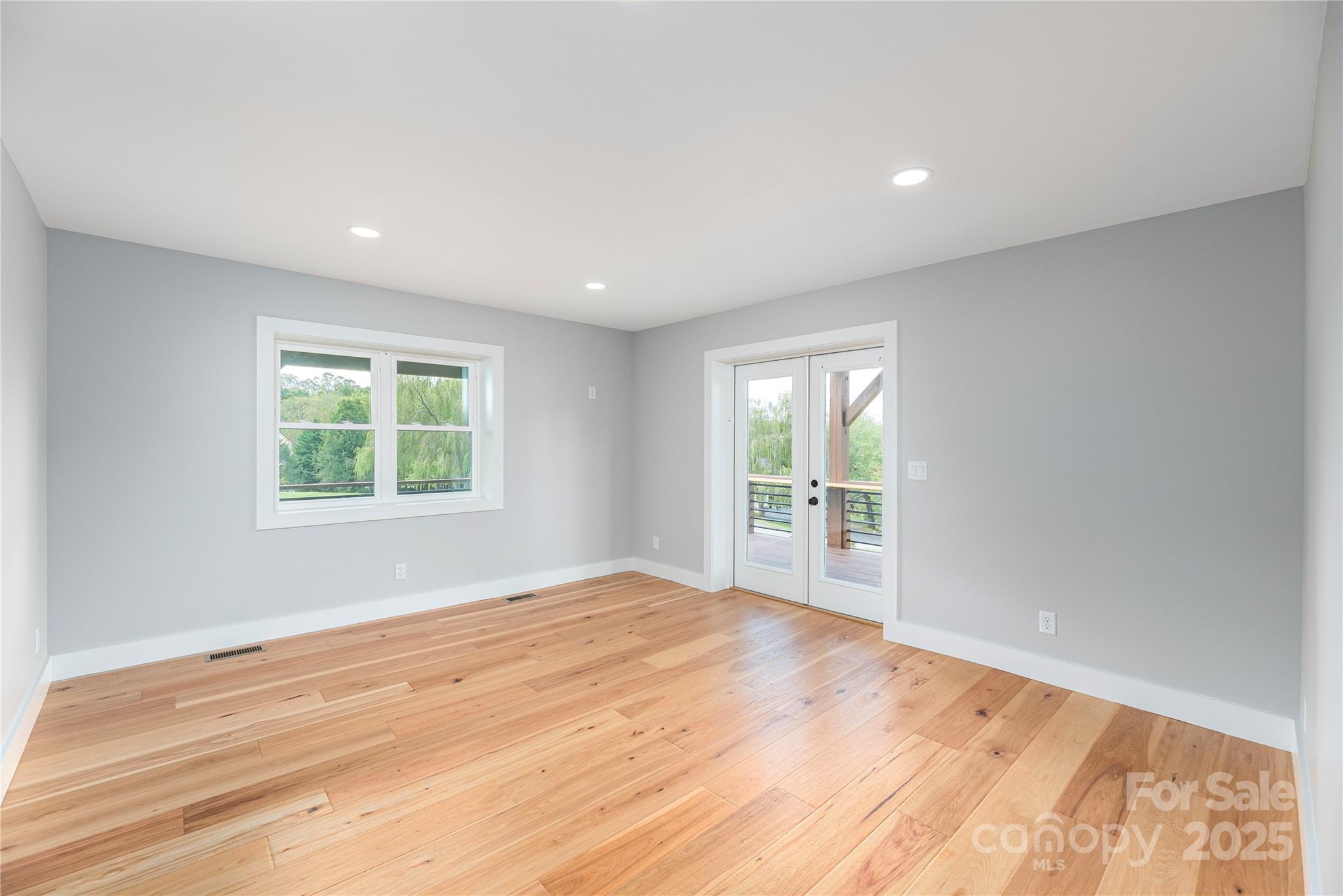 234 Erwin Hills Road Asheville, NC 28806 - Photo 15 of 47 a view of an empty room with wooden floor and a window