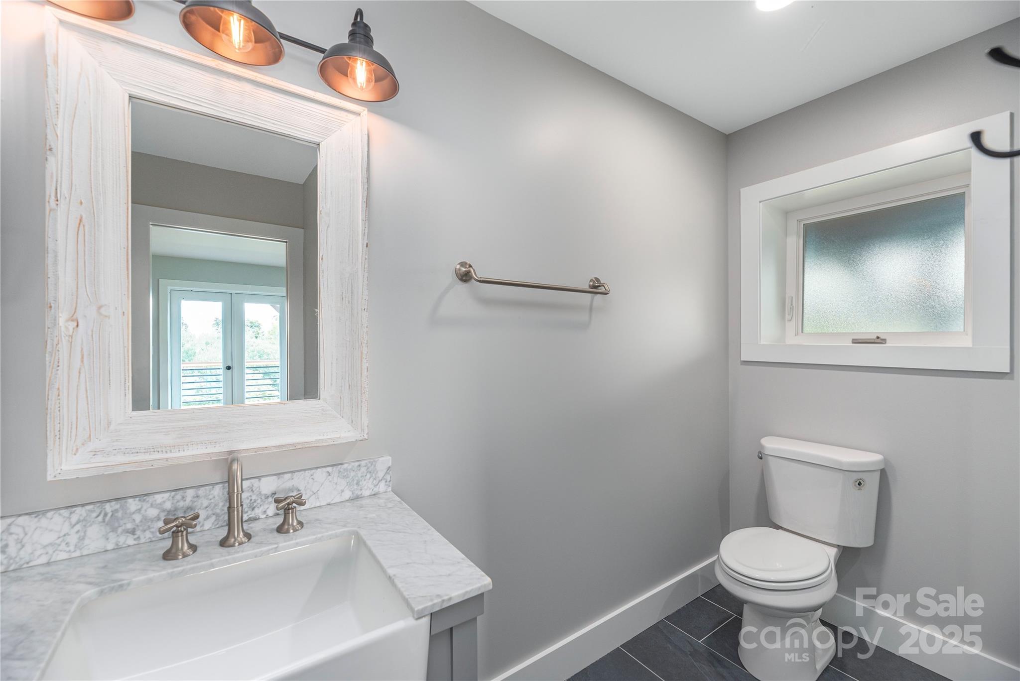 234 Erwin Hills Road Asheville, NC 28806 - Photo 18 of 47 a bathroom with a toilet sink and mirror