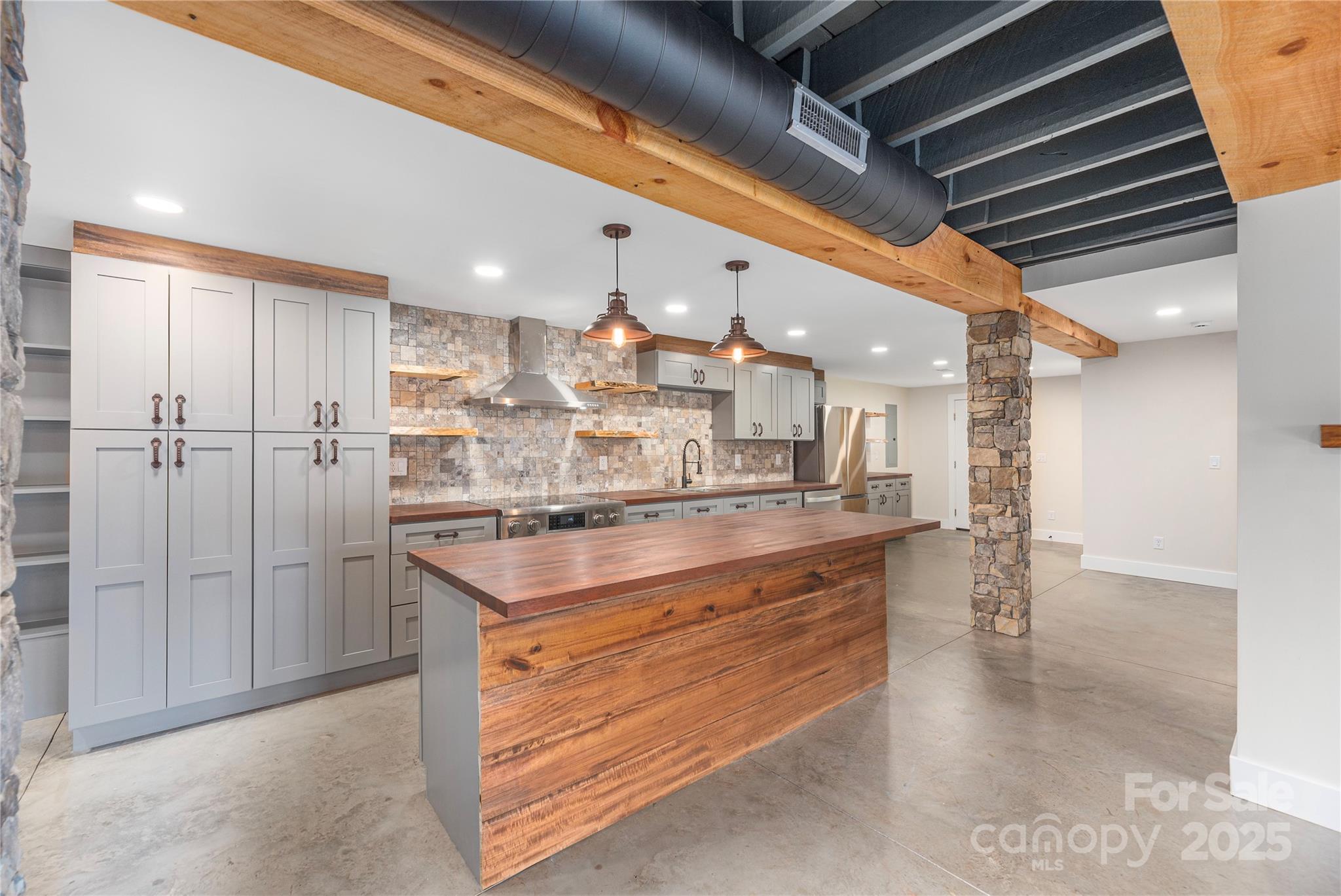 234 Erwin Hills Road Asheville, NC 28806 - Photo 32 of 47 a kitchen with kitchen island a sink appliances and cabinets